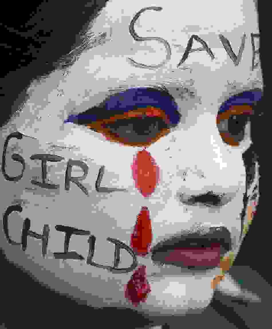 121685-a-girl-with-her-face-painted-with-an-awareness-message-on-female-foeti-1